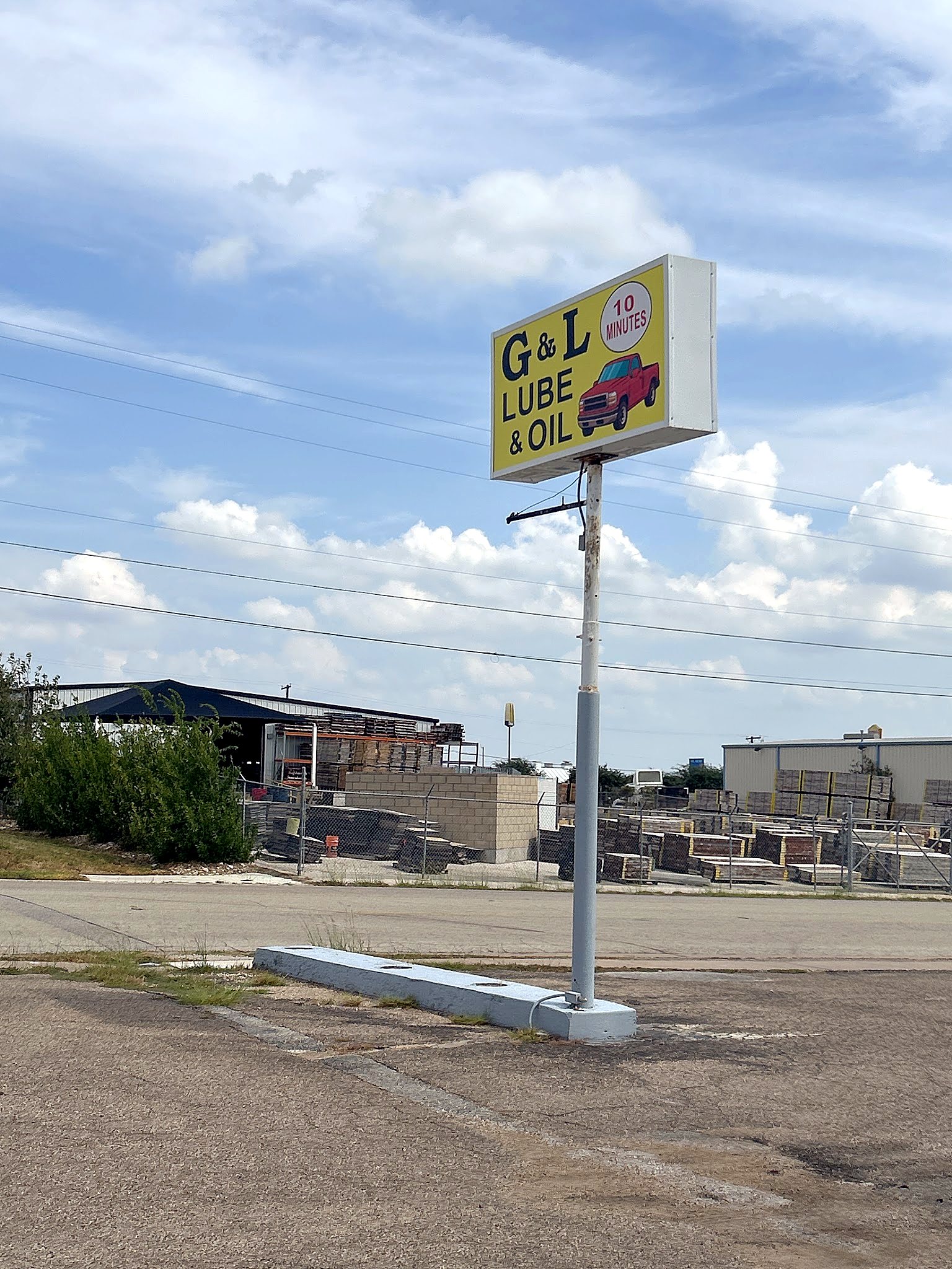 The G&L Lube & Oil roadside sign under a cloudy sky