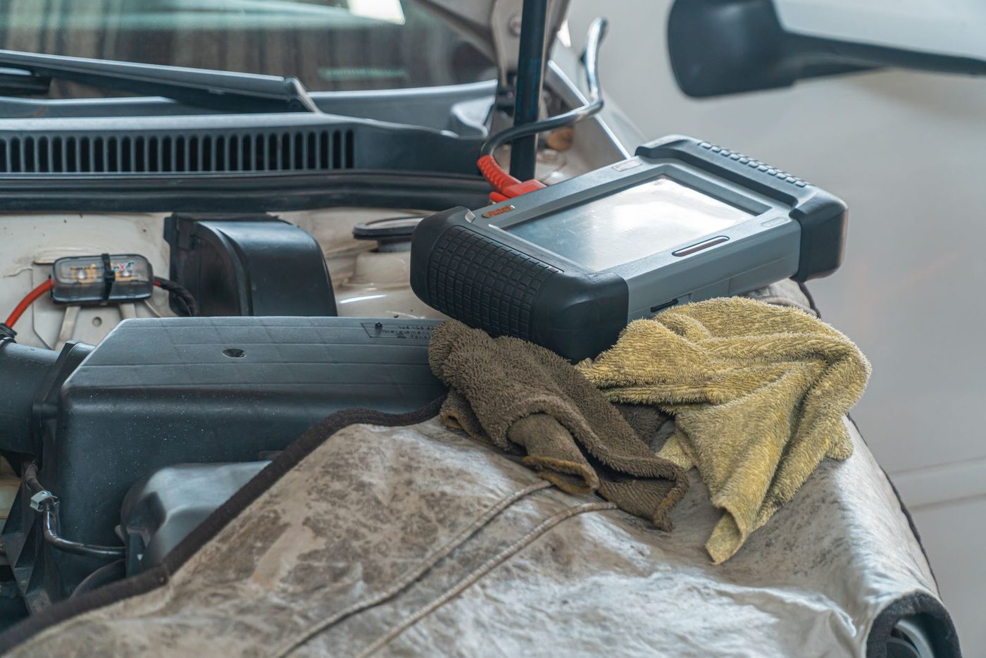 A diagnostic scanner plugged in under the hood
