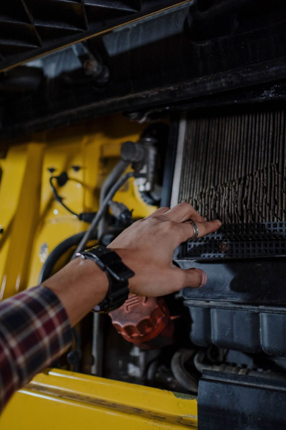 A hand checking an engine air filter