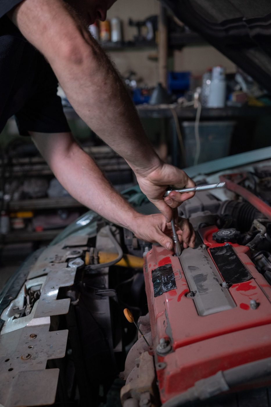 Hands working on an engine during a tune-up